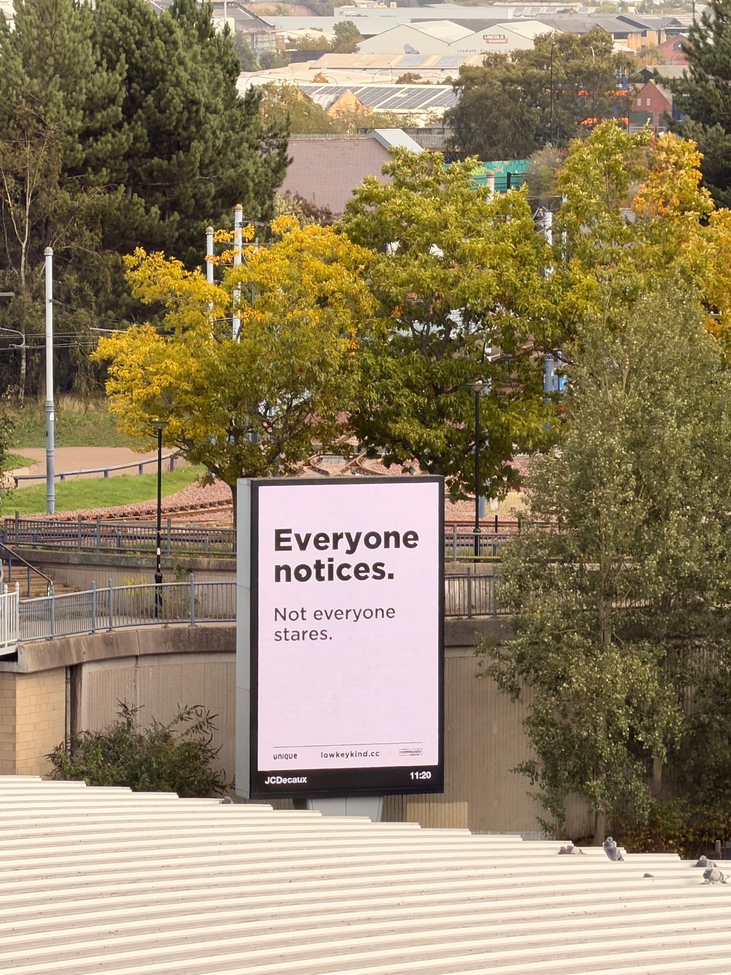 Low-key kind digital six-sheet beside tram lines and autumn trees in Sheffield